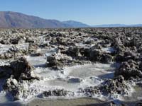 39-Devil's_Golf_Course_salt_formations_with_water_along_West_Side_Rd