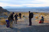 04-group_taking_a_break_before_heading_into_drainage-Las_Vegas_valley_in_distance