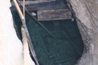 83-looking_down_into_the_well_through_the_grate-zoom_view-still_some_water,but_not_potable