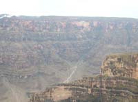 086-great_views_with_low_cloud_cover-side_canyon_helicopters_travel_out_of_main_canyon
