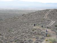 74-group_walking_along_old_road_towards_are_vehicles