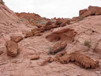 77-volcanic_rock_mixed_with_iron_oxide_among_sandstone