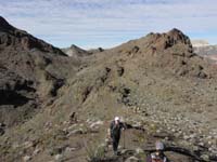 24-looking_back_at_group_heading_up_steep_slope_to_peak-route_visible_to_Pyramid_towards_left