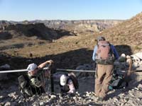 01-starting_the_hike_climbing_through_fencing_meant_to_keep_Bighorn_Sheep_from_going_this_way