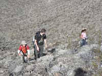 17-Kenny,Lawrence,and_Maia_hiking_up_steep_slope