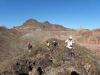 18-looking_back_at_group_hiking_along_ridge_near_Lower_Portal_Road-Hwy_93_in_distance