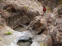 10-me_with_obstacles_we_climbed_around-below_me_and_behind_to_right_of_water_tanks-from_Luba