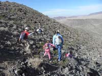 55-group_heading_down_steep_slope_with_loose_rocks,then_to_easier_drainage