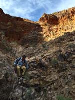 11-Colin_climbing_down_drainage-looking_back_to_where_we_started-from_Laszlo