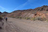 02-walking_up_road-turned_north_up_slope_to_ascend_peaks_to_right