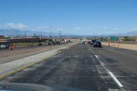 69-lots_of_traffic_other_direction,typical_this_time_of_year-road_needs_to_be_repaved-Strip_view_in_distance