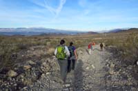 04-group_walking_along_dirt_road_with_nice_views_of_Las_Vegas_Valley_and_Spring_Mountains