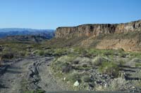 01-driving_down_Cranes_Nest_Wash_dirt_road-passing_by_wall_of_igneous_rock