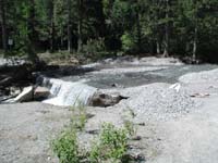 01-river_flowing_over_road_to_residential_area