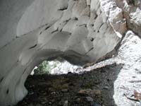 36-snow_arch_with_water_flowing_below_it_from_falls_to_the_right
