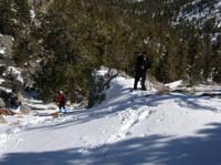 34-Larry_and_Chris_R._heading_down_slope_to_campground