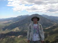 36-me_on_the_summit_with_Willow_Peak_and_Mount_Charleston_to_right_in_background