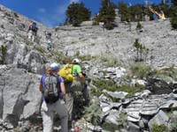 39-group_hiking_through_more_debris-body_of_plane