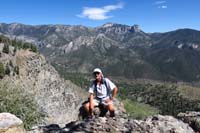 19-Laszlo_on_peak_with_Mummy_Mountain_in_background