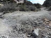 03-smaller_rocks_filled_between_big_rocks,layer_of_dirt,then_gravel-used_a_Bobcat_to_spread_it_all