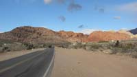 01-Calico_Hills-about_to_traverse_about_2.25_miles_from_left_to_far_right_red_peak_past_two_tan_humps