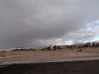 01-view_from_near_office_looking_west_toward_Red_Rock_and_first_approaching_storm_band