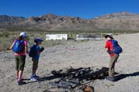 01-Sarah,Lexi,Kenny_checking_out_burned_debris_at_trailhead_with_peak_in_background