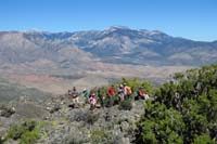 18-looking_back_at_group_taking_a_break_with_Spring_Mountains_in_distance