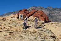 42-looking_back_at_group_walking_on_the_rock_with_Redcap_in_background