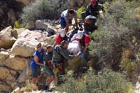 57-hiker_being_carried_in_a_basket_to_a_safe_spot_to_be_extracted