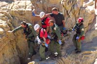 59-carefully_scrambling_rocks_carrying_the_injured_hiker