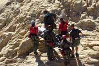 60-carefully_scrambling_rocks_carrying_the_injured_hiker