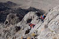 64-Ed_and_Luba_scrambling_rocks_with_limestone_arches_in_background