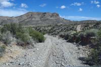 57-driving_back_up_that_dirt_road_to_right_to_avoid_tights_spots_to_left