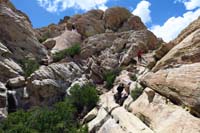 63-scrambling_down,Brett_enjoying_cool_water_flowing_down_rocks