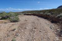 57-looking_back,dirt_road_is_now_a_washed_out_wash