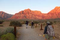 02-group_hiking_up_trail-Indecision_Peak_ahead_glowing_during_sunrise