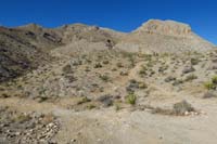 07-continuing_along_rough_dirt_road_to_L,bike_trail_to_R-Lonely_Pinyon_Mt_in_distance