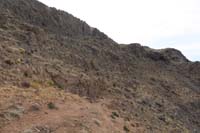 21-game_trails_leading_to_a_cave_for_shelter,we_are_going_higher_below_cliff