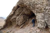 49-Brett_checking_out_a_cave_below_peak_as_we_descend