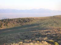 10-trail_of_cows_moving_below_and_to_right_of_rocks_sticking_out