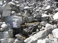 43-water_flowing_under_the_rocks_above_break_the_surface_on_at_this_spot