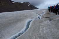 037-walking_along_side_a_stream_flowing_on_the_glacier_surface