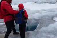 112-Kenny_gets_to_look_into_a_moulin_tunnel-with_support_from_the_guide